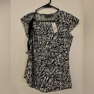 Nice outfit. Top is an XS, and, pants are 00 Petite.